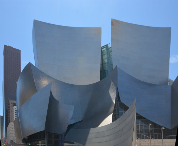 Moderner Glaswand-Konzerthall in Los Angeles mit Treppen und Geländern zum Eingang, umgeben von Menschen, anderen Gebäuden und einem klaren blauen Himmel.
